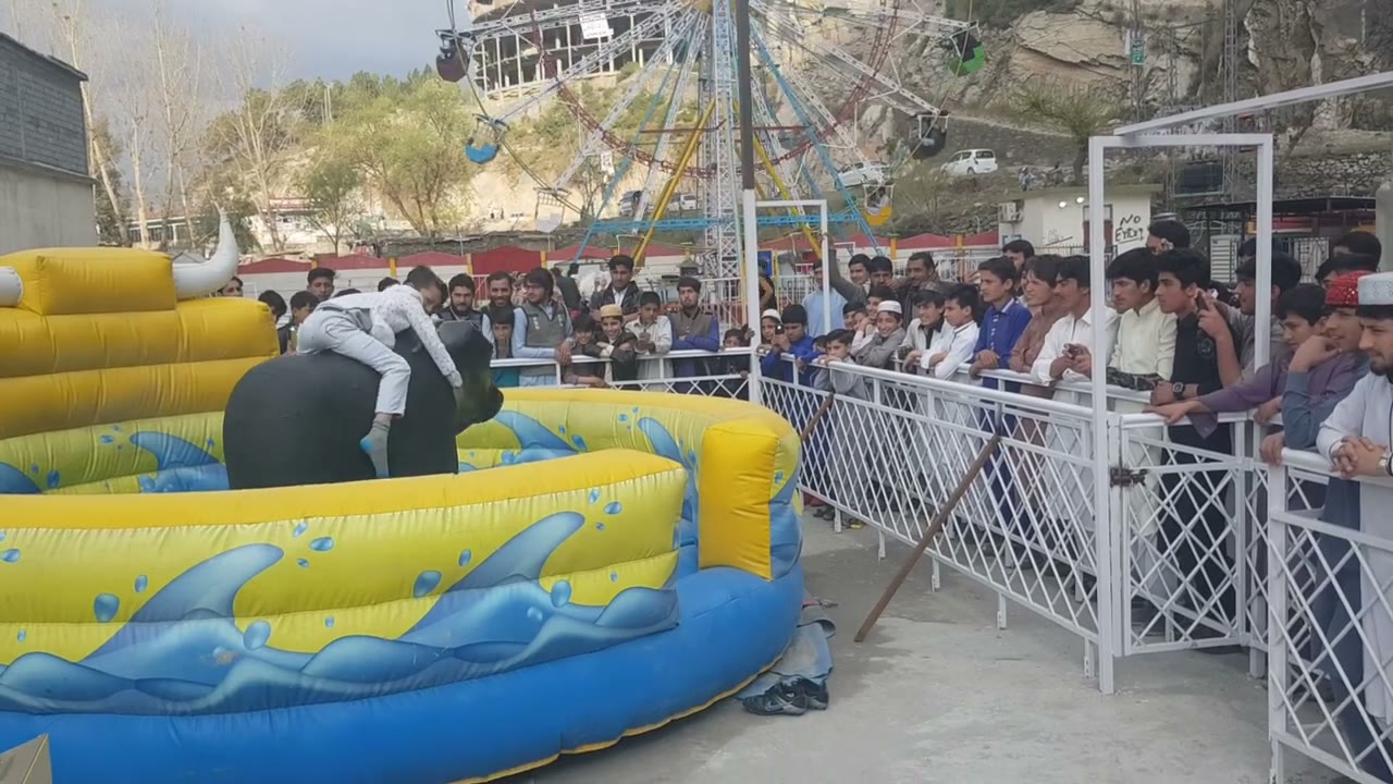 Mechanical bull ride in action at an outdoor fair