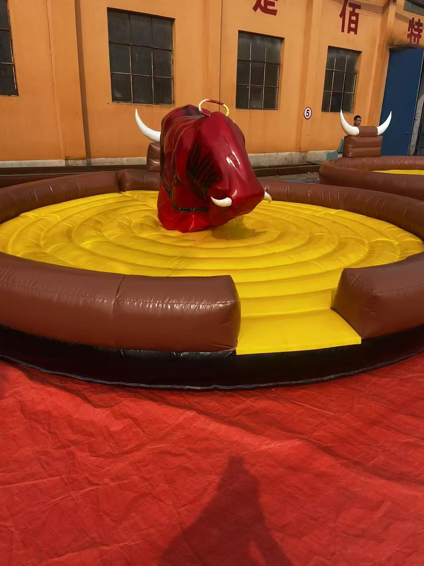 Mechanical bull running at a night event under floodlights